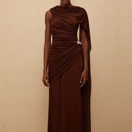 Nora Maxi Dress in Brown Sleeveless Bateau Neck Fitted Waistline Knitted Construction Asymmetrical Ruched Detailing Ribbon Design Silver-tone Hardware Side Zip Fastening Graceful Maxi Length