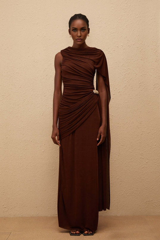 Nora Maxi Dress in Brown Sleeveless Bateau Neck Fitted Waistline Knitted Construction Asymmetrical Ruched Detailing Ribbon Design Silver-tone Hardware Side Zip Fastening Graceful Maxi Length