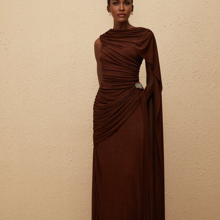 Nora Maxi Dress in Brown Sleeveless Bateau Neck Fitted Waistline Knitted Asymmetrical Ruched Detailing Ribbon Design Silver-tone Hardware Side Zip Fastening Graceful Maxi Length