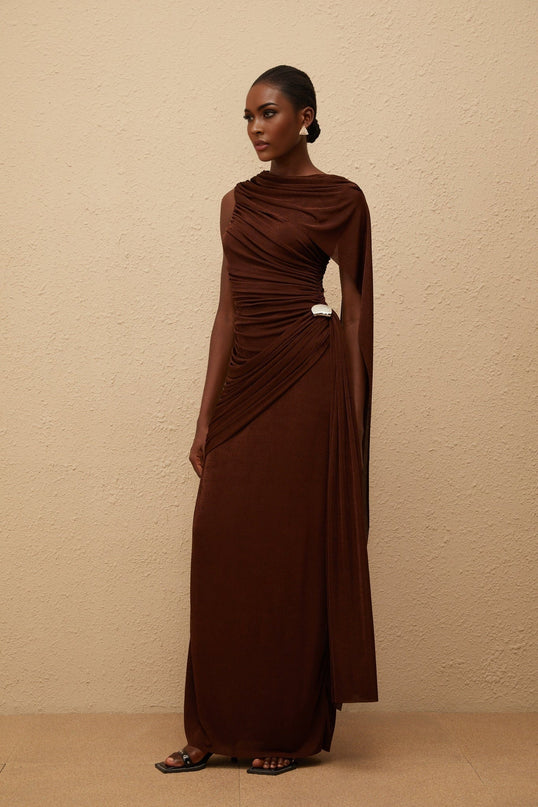 Nora Maxi Dress in Brown Sleeveless Bateau Neck Fitted Waistline Knitted Construction Asymmetrical Ruched Detailing Ribbon Design Embossed Silver-tone Hardware Side Zip Fastening Graceful Maxi Length
