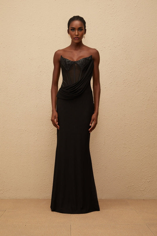 Ofelia Maxi Dress in Black with boned corset bodice, sequin embellishments, ruched detailing, and flared hem