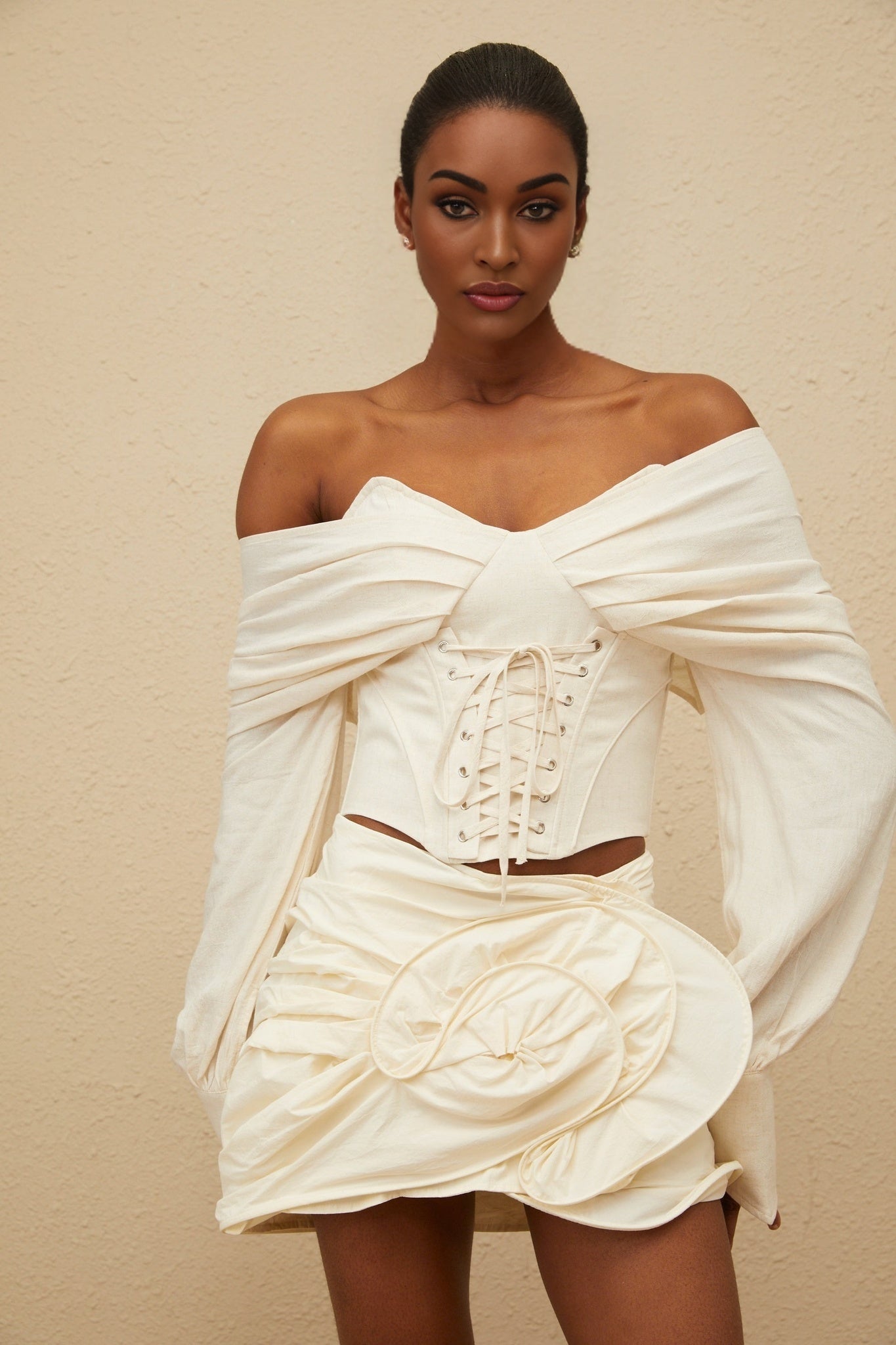 Off white off the shoulder cropped top with boned bodice and lace-up detailing