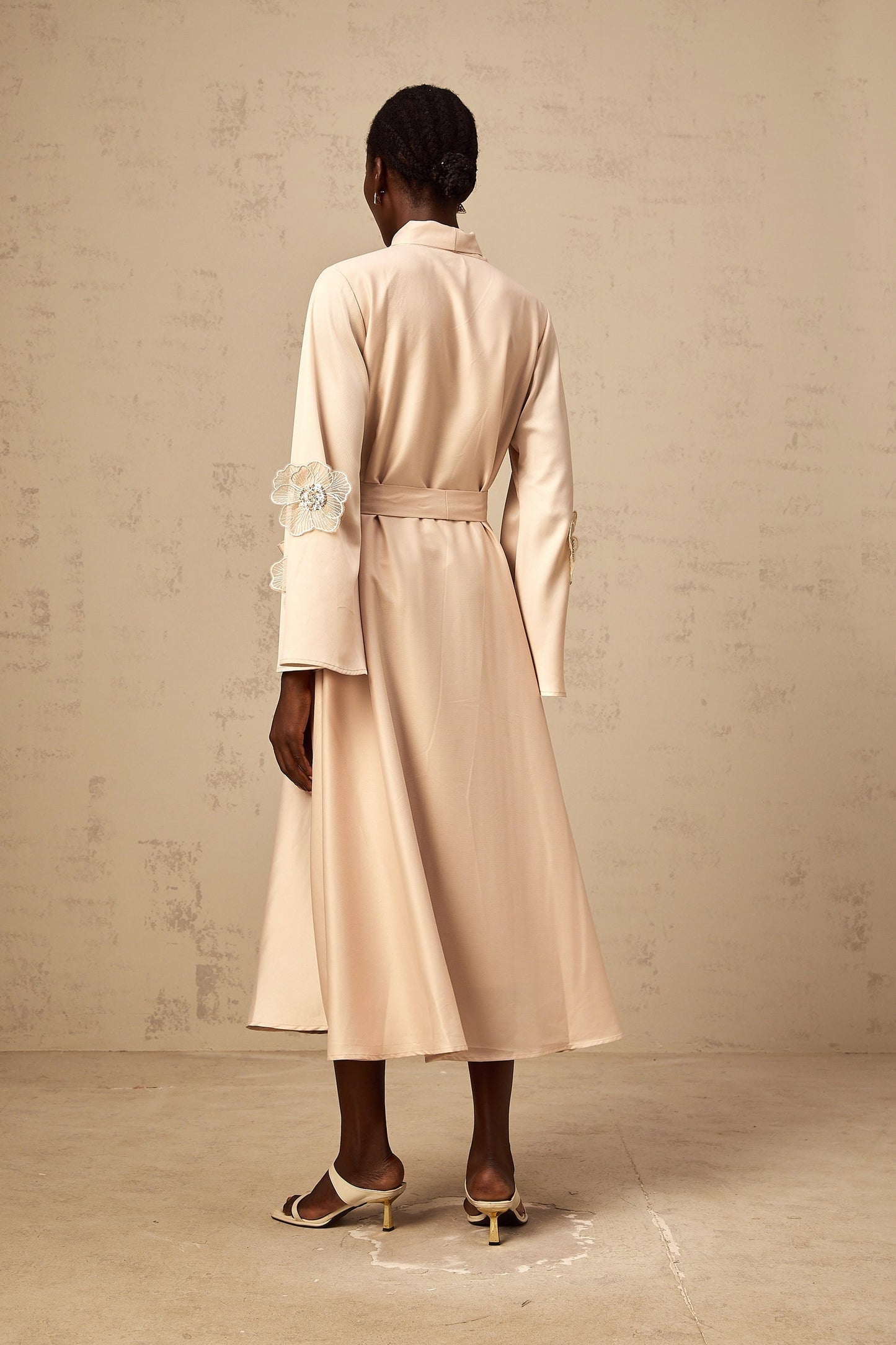 Orane flared midi dress in neutral tones with tied waist and floral applique details