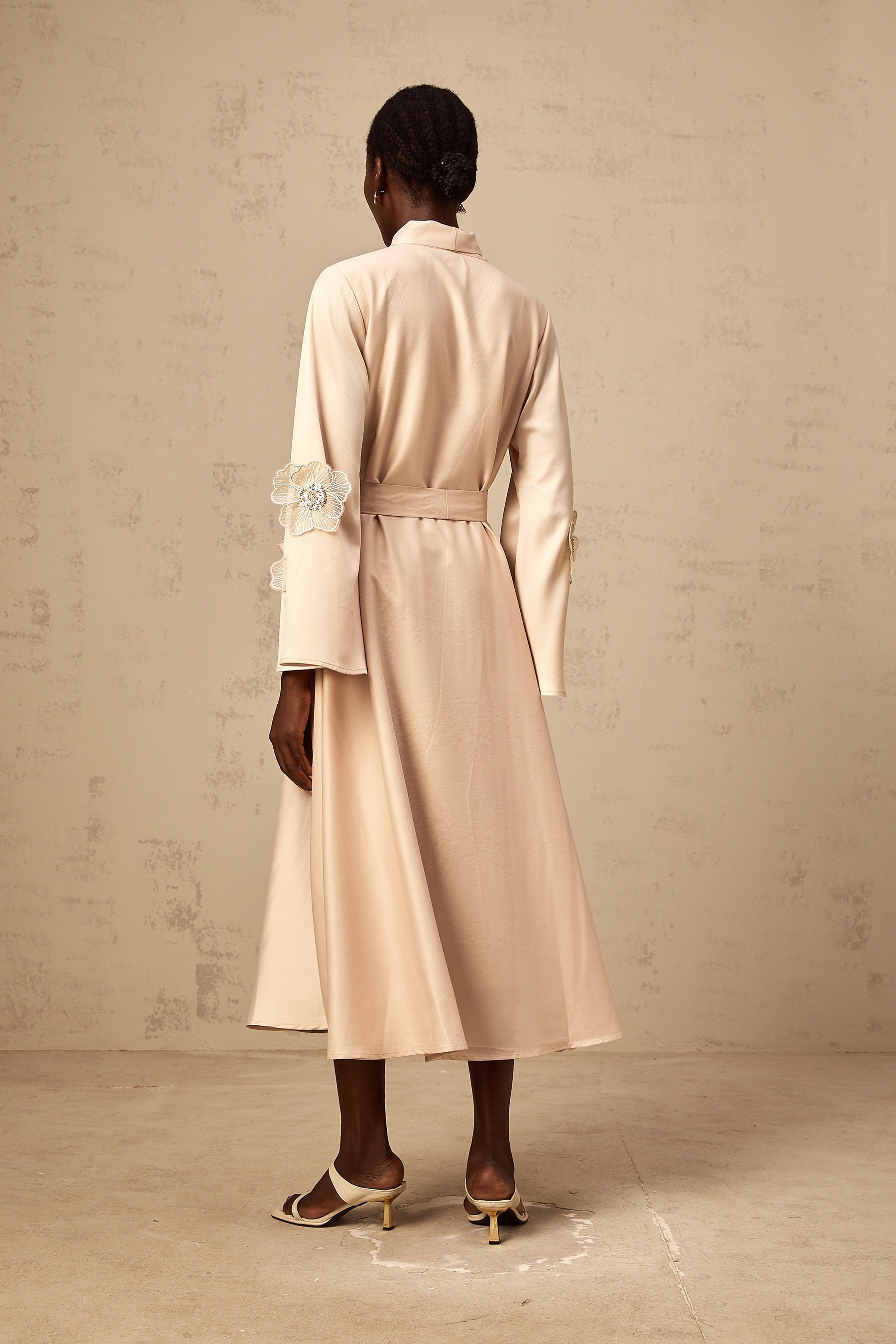 Orane flared midi dress in neutral tones with tied waist and floral applique details