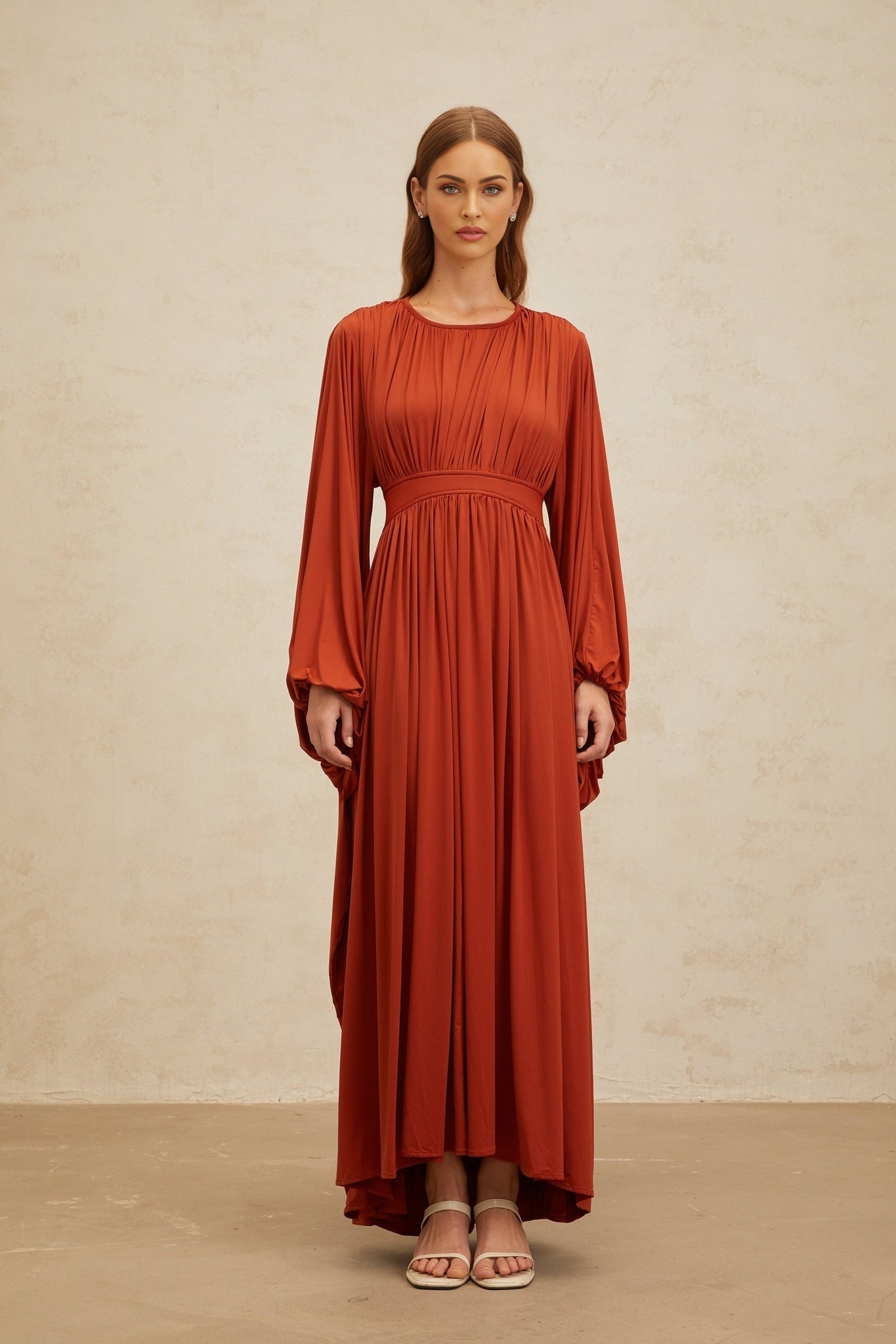 Orange long puff sleeve maxi dress with cinched waist and pleated detailing