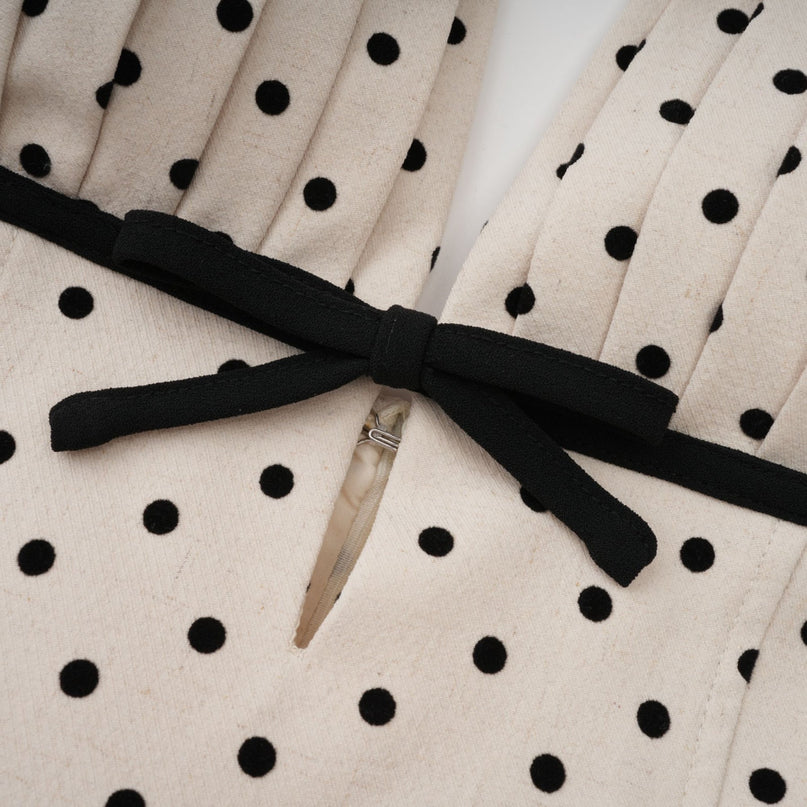 Ornella Midi Dress in White with Black Polka Dots sartorial masterpiece halterneck open back bow embellishment polka-dot print puff skirt calf-length hemline rear button zip fastening special occasions classic charm contemporary style