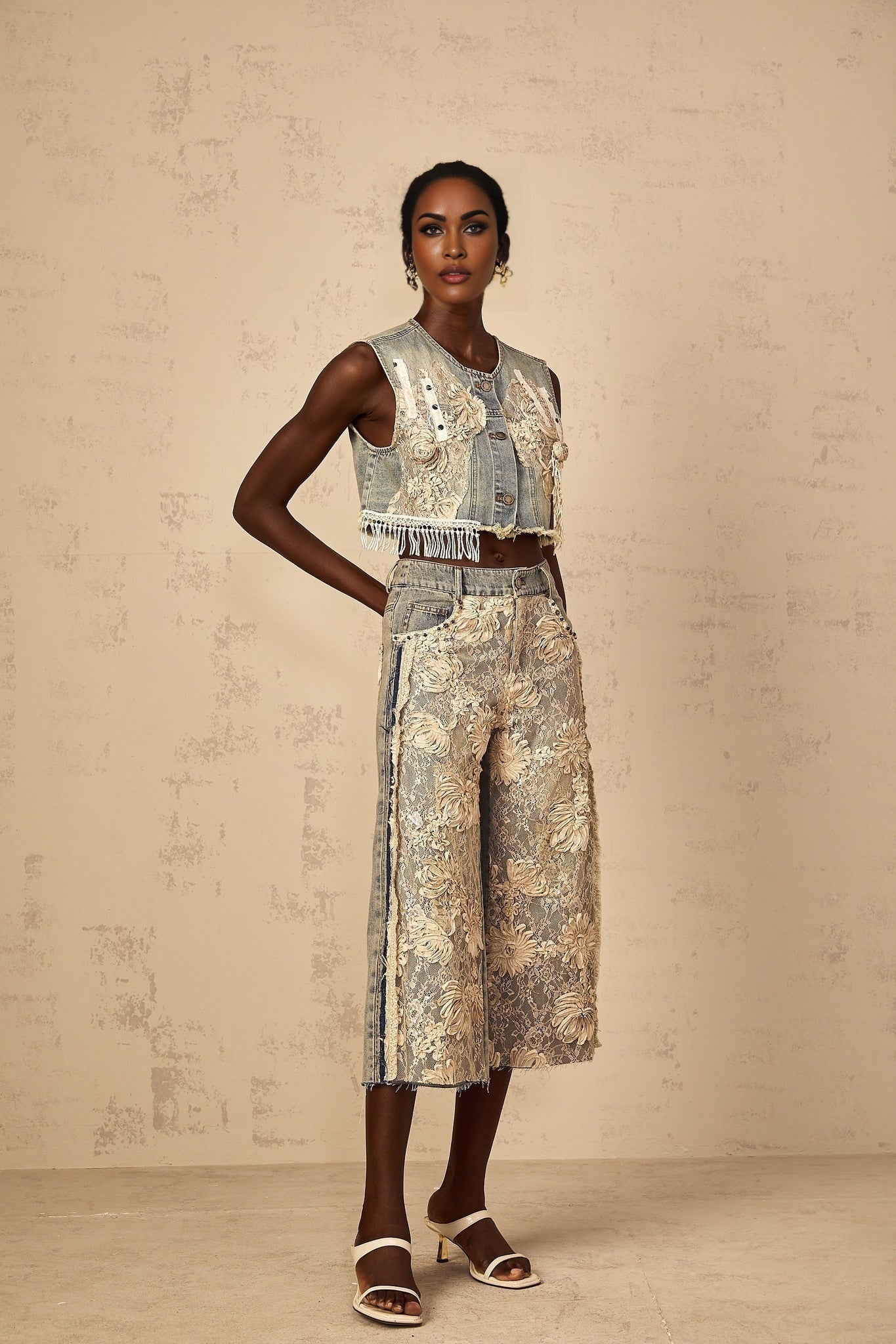 Pair of denim jeans with blue floral lace panels on the sides