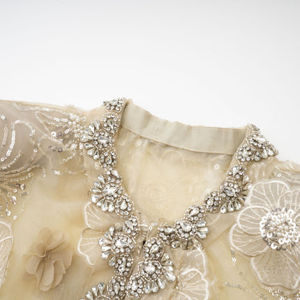 Paityn Floral Appliqué Jacket in Neutrals 100% Polyester with intricate floral appliqués and delicate crystal embellishments, semi-sheer construction, hook and eye fastening, long sleeves, and round neck for sophistication and charm