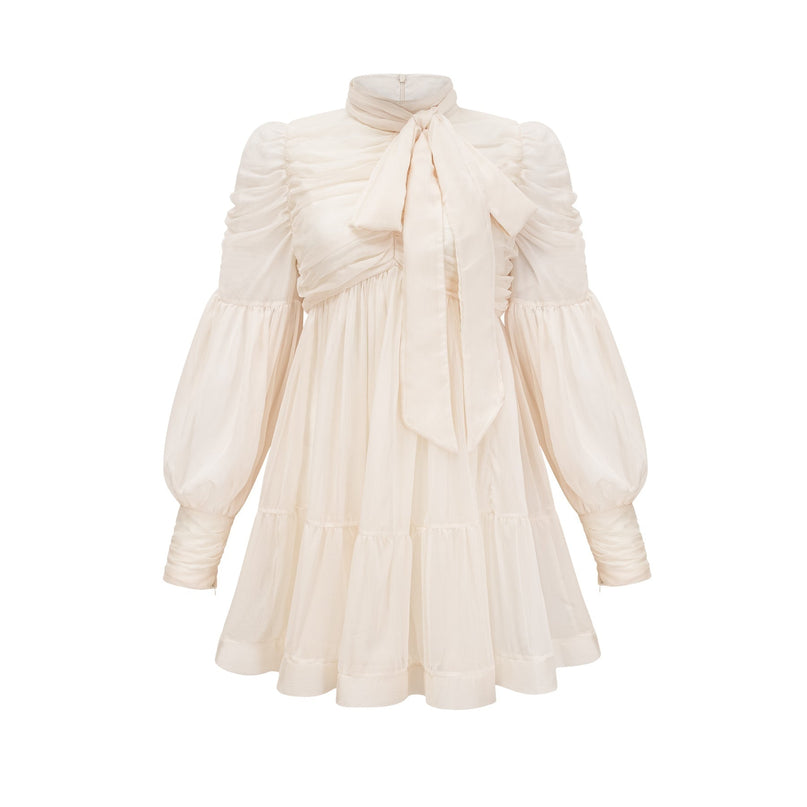 Paola Mini Dress in Neutrals sophisticated mock neck long puff sleeves tuck detailing fully pleated skirt rear zip fastening luxurious blend of Terylene fiber and Spandex