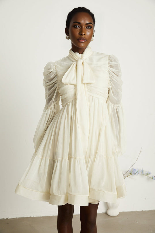 Paola Neutrals Mini Dress mock neck long puff sleeves buttoned cuffs tuck detailing gathered design pleated skirt rear zip fastening luxurious blend Terylene fiber Spandex timeless beauty