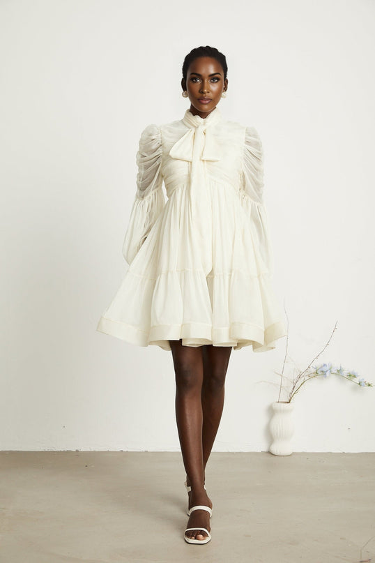 Paola Neutrals Mini Dress mock neck long puff sleeves buttoned cuffs tuck detailing gathered design pleated skirt rear zip fastening luxurious blend Terylene fiber Spandex timeless beauty