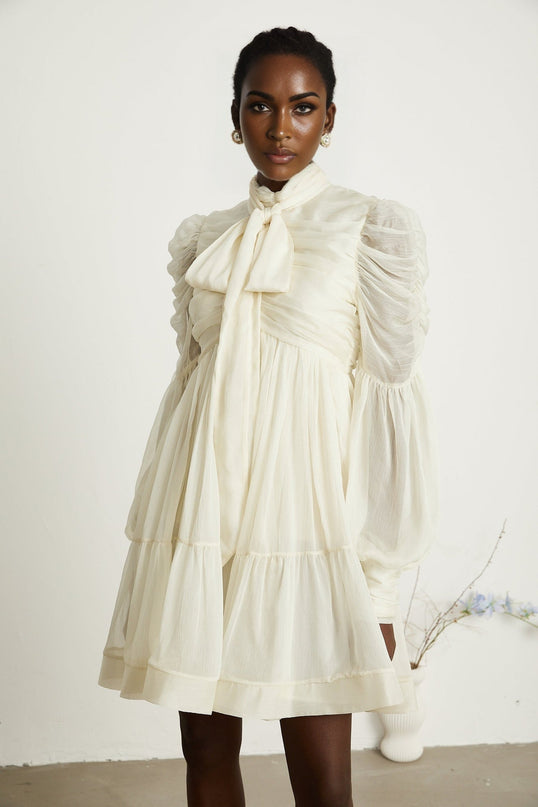 Paola Neutrals Mini Dress mock neck long puff sleeves buttoned cuffs tuck detailing gathered design pleated skirt rear zip fastening luxurious blend Terylene fiber Spandex timeless beauty