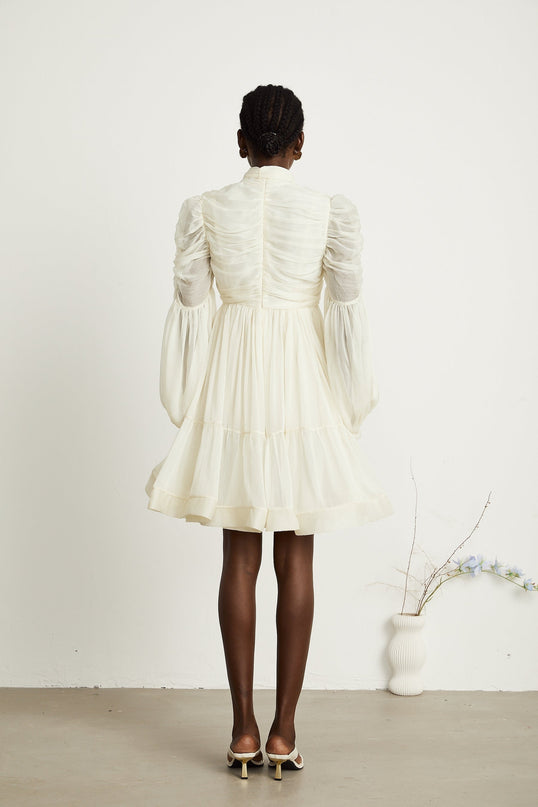 Paola Neutrals Mini Dress mock neck puff sleeves buttoned cuffs tuck detailing gathered design pleated skirt rear zip fastening thigh-length luxurious blend Terylene fiber Spandex timeless beauty