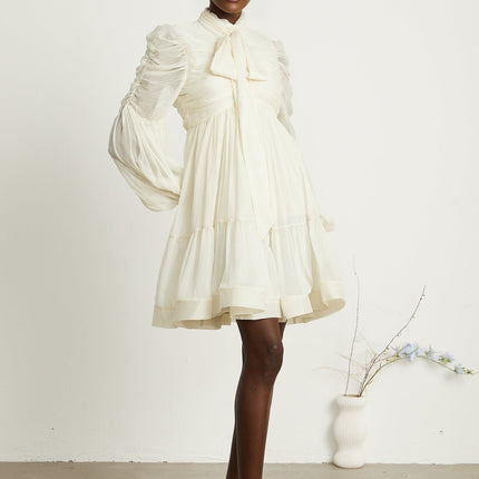 Paola Neutrals Mini Dress mock neck long puff sleeves buttoned cuffs tuck detailing gathered design pleated skirt rear zip fastening luxurious blend Terylene fiber Spandex timeless beauty