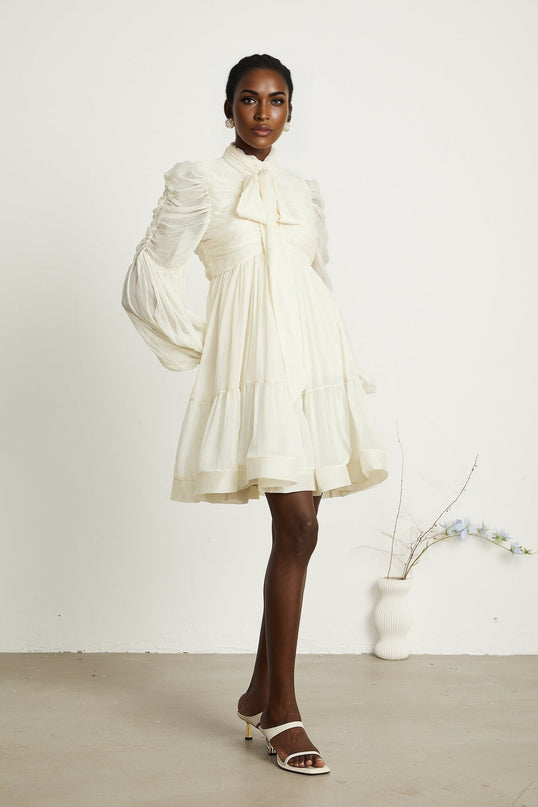 Paola Neutrals Mini Dress mock neck long puff sleeves buttoned cuffs tuck detailing gathered design pleated skirt rear zip fastening luxurious blend Terylene fiber Spandex timeless beauty