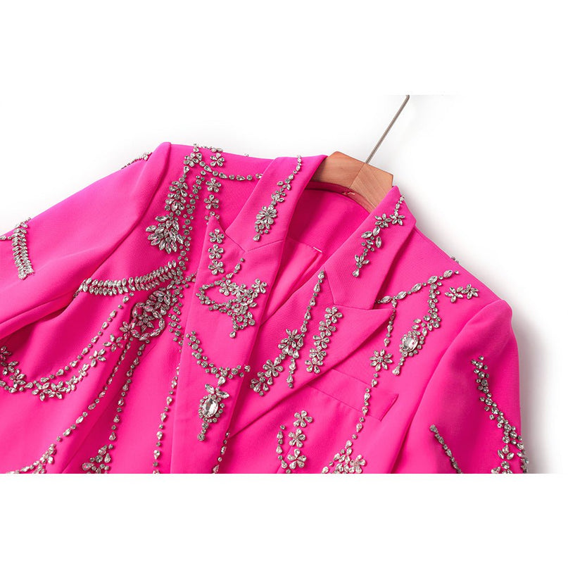 Oversized double-breasted pink coat with floral-inspired embellishments and rhinestone appliqué accents