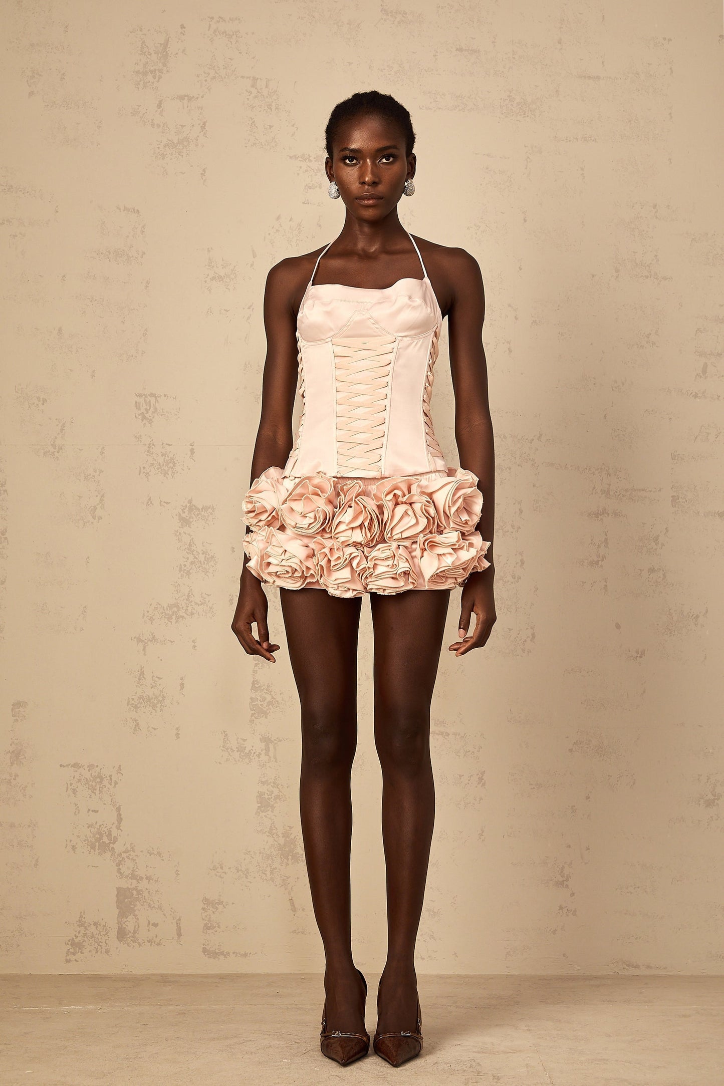 Pink faux flower lace up top and matching skirt set named Jeanne on a plain background