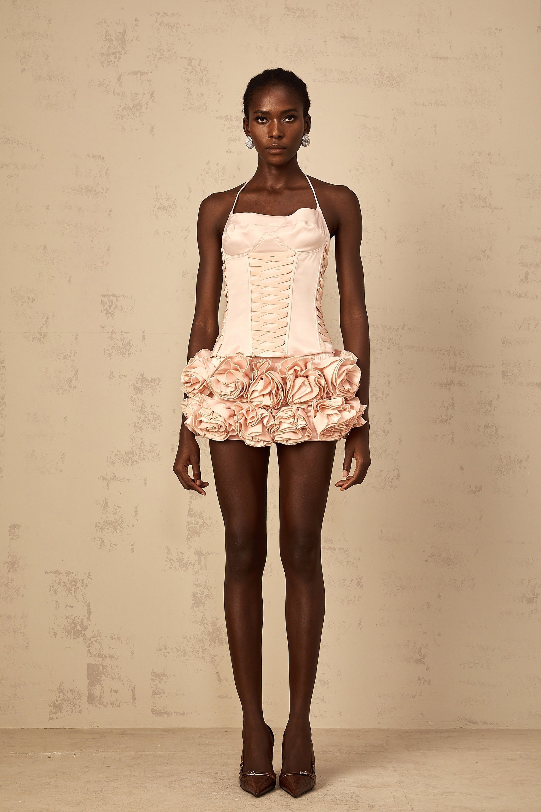 Pink faux flower lace up top and matching skirt set named Jeanne on a plain background