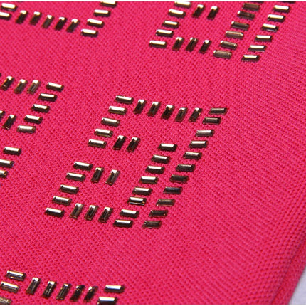 Bold pink geometric patterned cutout dress with metallic accents
