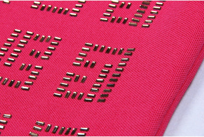 Bold pink geometric patterned cutout dress with metallic accents