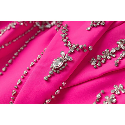 Oversized double-breasted pink coat with floral-inspired embellishments and rhinestone appliqué accents