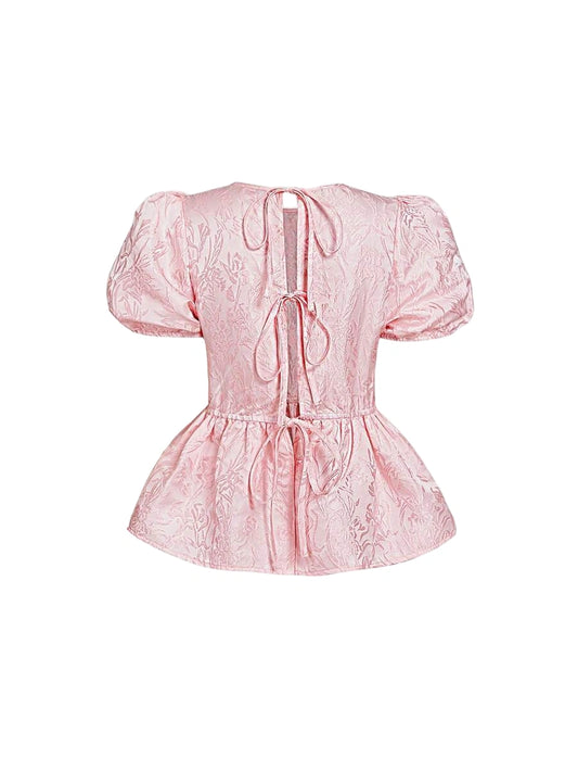 Pink jacquard blouse with puff sleeves and open back with ties