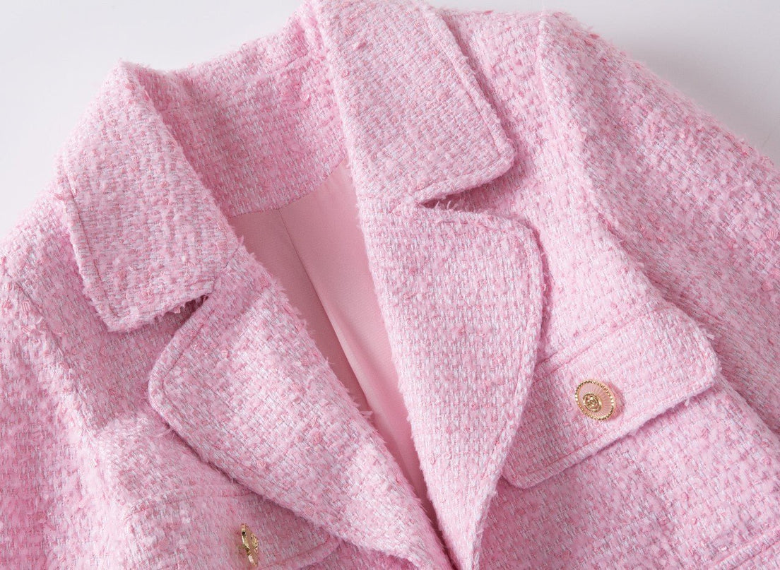 Pink tweed blazer with gold button accents and tailored silhouette