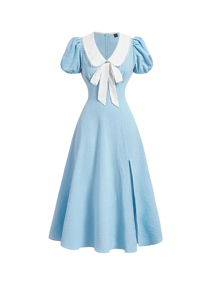 Vintage blue dress with puff sleeves and white bow detail, A-line style with a slit