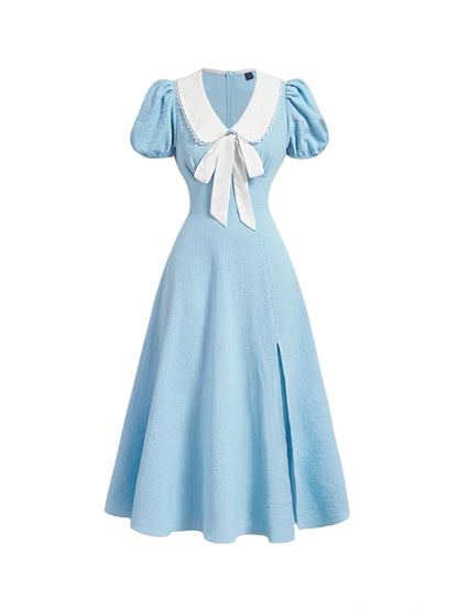 Vintage blue dress with puff sleeves and white bow detail, A-line style with a slit