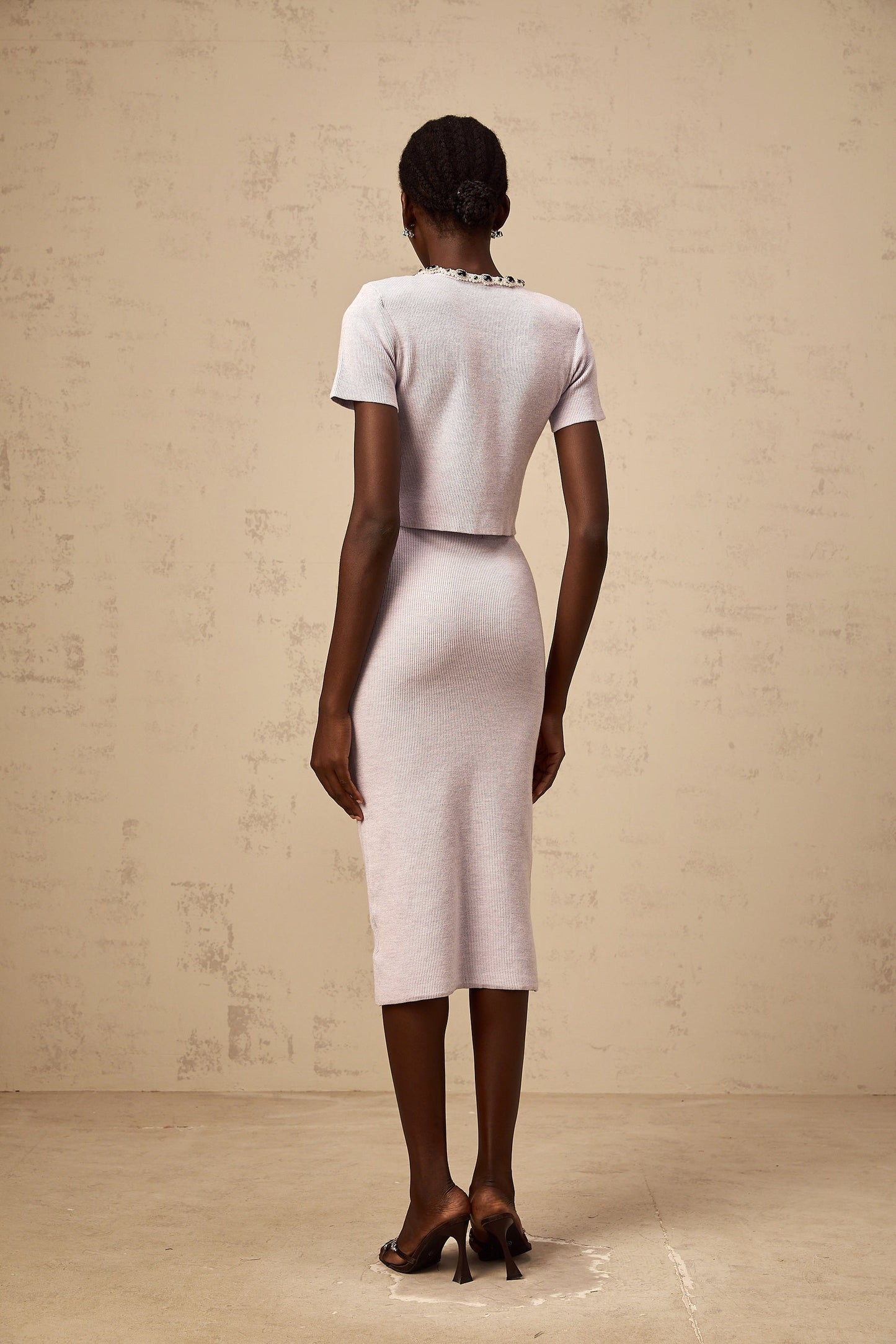 Purple beaded knit top and matching skirt set named Abbie featuring a beaded design on a knitted fabric