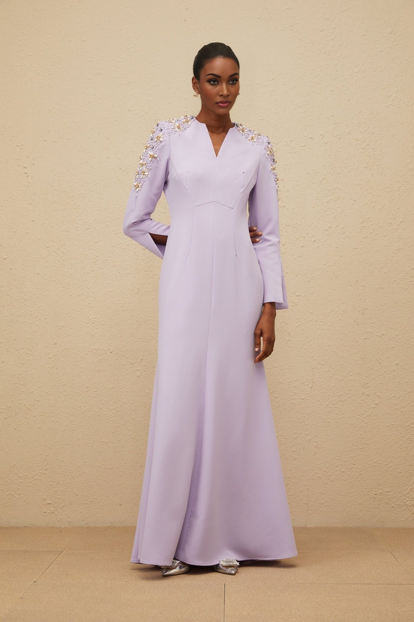 Purple long sleeve V-neck dress with faux pearl and crystal embellishments, fitted waistline, flared hem, and rear zip fastening
