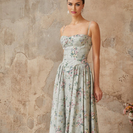 Raven Midi Dress in enchanting green floral square neck sleeveless silhouette adjustable spaghetti straps cinched waist shirred effect boned bodice mesmerizing floral print side slit pockets rear zip fastening calf length 100% Terylene fiber
