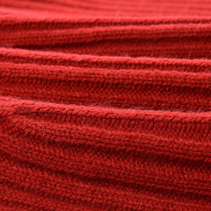 Red A-line sweater with black details and bow accents