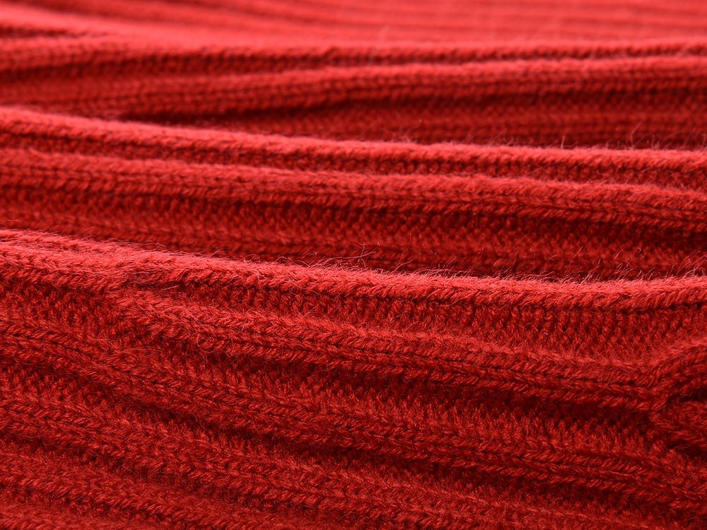 Red A-line sweater with black details and bow accents