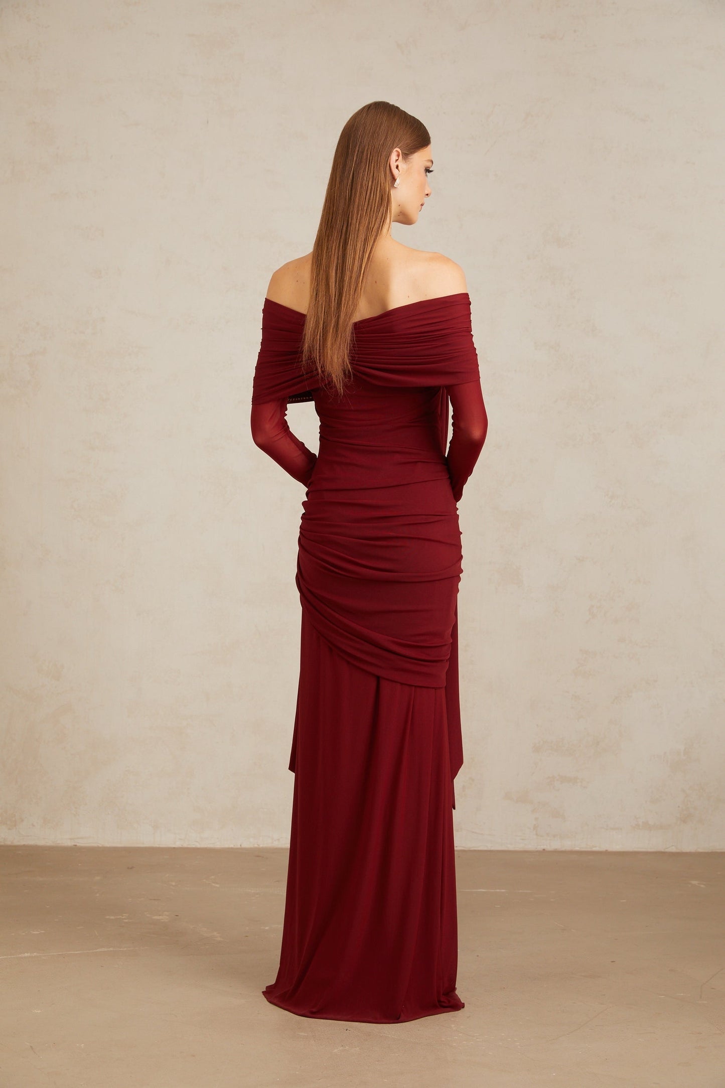 Red off the shoulder long sleeve dress with front tie detail and pleated, asymmetrical, ruched, and draped detailing