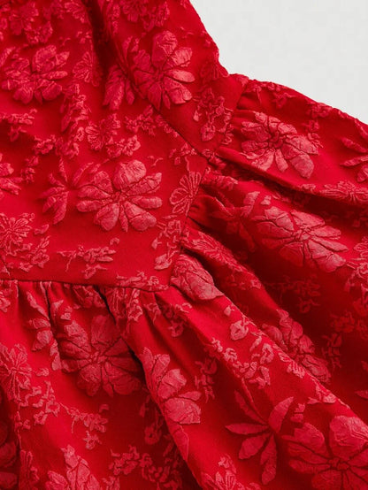 Elegant red jacquard mini dress with a structured bodice, square neckline, and flared skirt, featuring intricate floral patterns for a sophisticated look