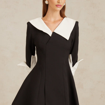 Rowan Black Color Block Mini Dress V-Neckline Asymmetrical Lapels Cinched Waist Flare Skirt Front Slit Long Sleeves Rear Zip Fastening Thigh Length