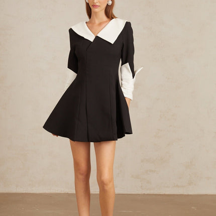 Rowan Black Color Block Mini Dress V-Neckline Asymmetrical Lapels Cinched Waist Flare Skirt Front Slit Long Sleeves Rear Zip Fastening Thigh Length