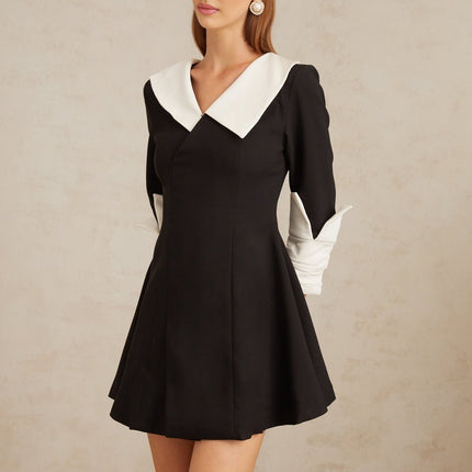 Rowan Black Color Block Mini Dress V-neckline Asymmetrical Lapels Cinched Waist Flare Skirt Front Slit Long Sleeves Rear Zip Fastening Thigh Length
