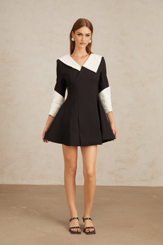 Rowan Black Color Block Mini Dress V-Neckline Asymmetrical Lapels Cinched Waist Flare Skirt Front Slit Long Sleeves Rear Zip Fastening Thigh Length