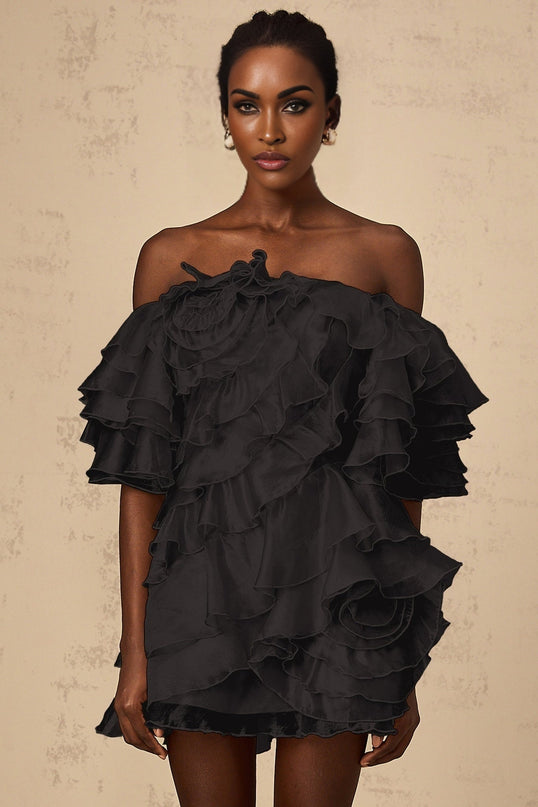 Short black mini dress with asymmetric design and cerise flounce detail