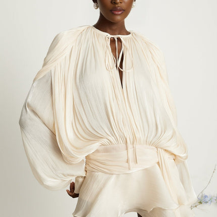 Sienna Mini Dress Neutrals Dramatic Draped Silhouette Glitter Detailing Pleating Ruffled Hem Shoulder Pads Semi-Sheer Construction Twist Design Buttoned-Cuff Sleeves Glamour