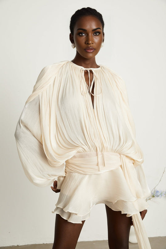 Sienna Mini Dress Neutrals Dramatic Draped Silhouette Glitter Detailing Pleating Ruffled Hem Shoulder Pads Semi-Sheer Construction Twist Design Buttoned-Cuff Sleeves Glamour