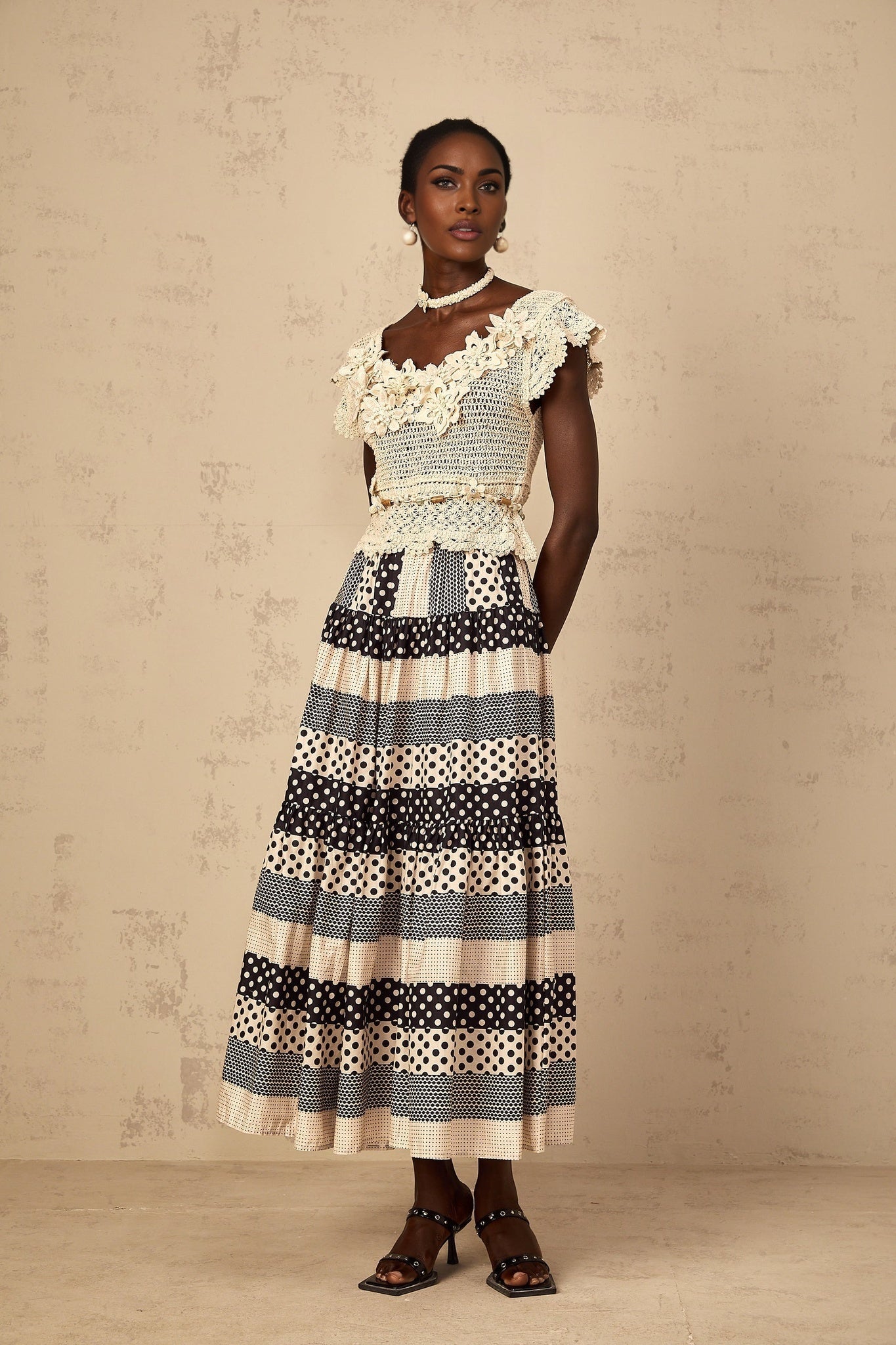 Sleeveless knit top with colorful three dimensional floral beaded embellishments in a crochet pattern