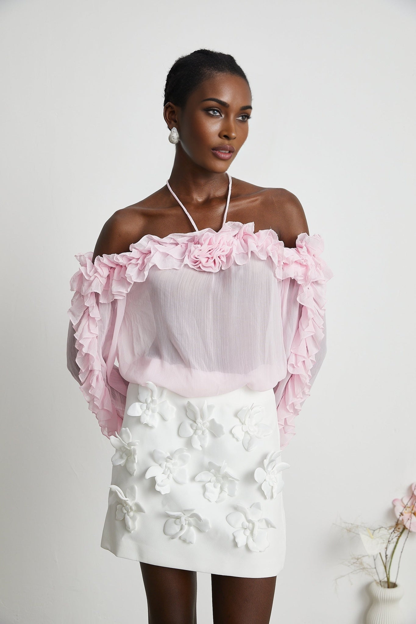 Sleeveless pink semi sheer top with a straight neckline