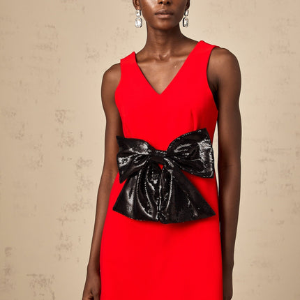 Sleeveless red mini dress with v neckline and sequin bow detail