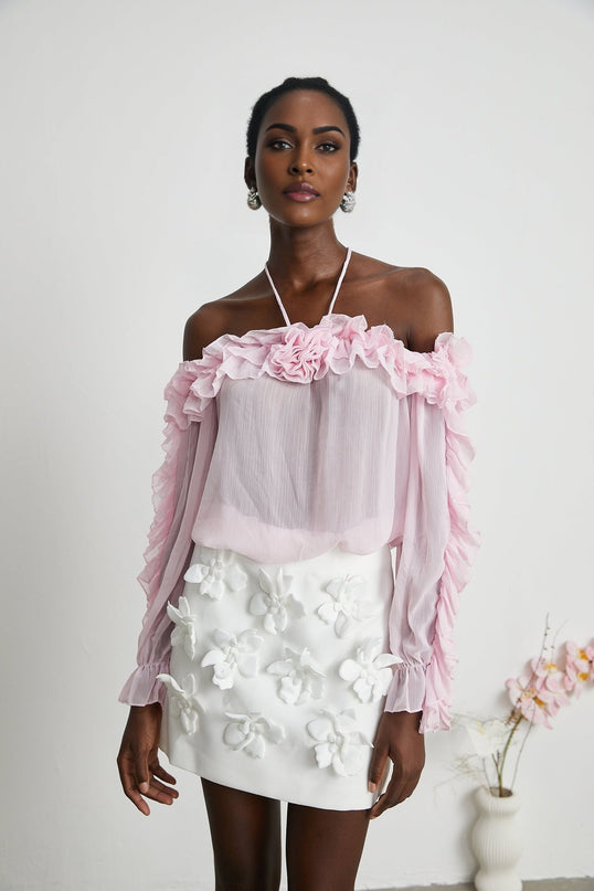 Sleeveless sheer pink top with straight neckline and formfitting design