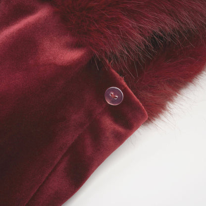 Strapless black velvet mini dress with white faux fur trim at top and bottom edges