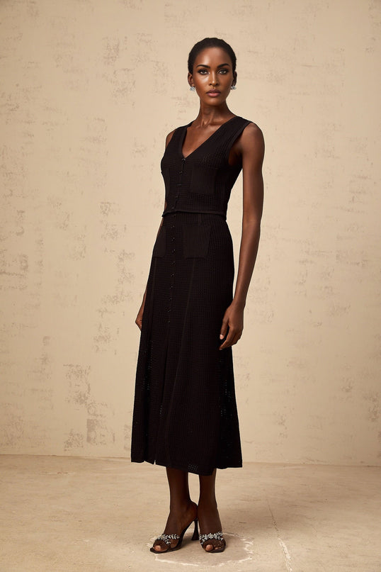 Teresa Black Pointelle Knit Top Skirt Set V Neck Sleeveless Design Front Patch Pockets Ribbed Hem Front Buttons Elasticated Waistband Front Slit Decorative Buttons Luxury Modern Silhouette 64% Viscose 36% Nylon Half Lining Calf Length Finish