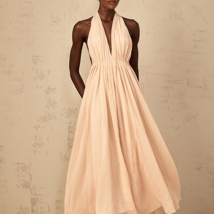 Teresa Maxi Dress in Peach Pink and Neutrals halter-neck shirred tulle open back design cinched waist 100% Terylene fiber rear tie zip fastening special occasions